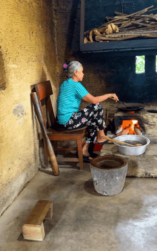 Balinese lady roasting coffee beans at a local coffee plantation